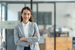 © crizzystudio - Attractive asian businesswoman standing with crossed arms and looking at camera in office confident and happy with business success