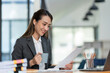 © crizzystudio - Beautiful and confident Asian businesswoman holding a cup of coffee to drink during break Relax with your own business happily in the office.
