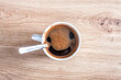 Coffee cup with funny smiling face, top view. Coffee open smile mouth in white mug, pareidolia effect