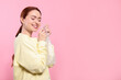 © New Africa - Woman popping bubble wrap on pink background, space for text. Stress relief