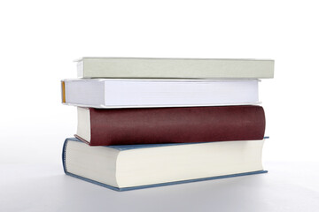 Stack of different books on white background