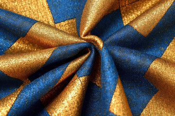 Poster - Thick cotton fabric with square print on blue and yellow with folds.