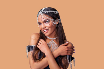 Fashion Portrait beautiful African American Woman with Perfect oriental make-up and white gold and diamond jewelry on head and neck model smiles and looks at the camera. isolated.    