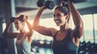 © Oliver - Two women friends working out with dumbbells in a gym