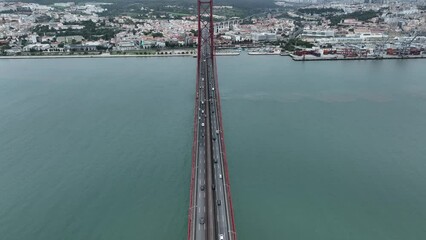 Poster - Traffic on The 25 April bridge (Ponte 25 de Abril) located in Lisbon, Portugal, crossing the Tagus river. Drone. 4k