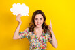 Portrait of excited pretty lady hand hold empty space cloud figure card point finger isolated on yellow color background