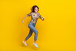 © deagreez - Full body size photo of running motivation young woman wear spring time outfit explore environment isolated on yellow color background