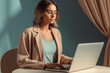 © BORIS - A pretty young woman wearing glasses working focused on laptop in a modern home office