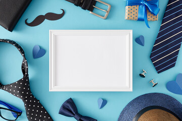 Happy Father's Day concept. Top view flat lay of gift box black mustache men's accessories and paper hearts on light blue background with blank frame for text or advert