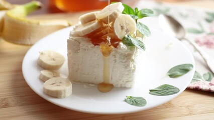 Wall Mural - Portion of homemade milk curd with banana slices and honey