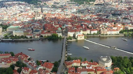 Canvas Print - Prague Old Town in Czech Republic with Famous Sightseeing Places in Background. Charles Bridge Iconic 14th century Structure with View, Vltava river and Prague Cityscape. Must Visit City. Drone, 4k