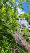 Footage Of A Gorgeous Spring Landscape With A Flowing Waterfall Over Large Rocks Surrounded By Lush Green Trees And Plants At Amicalola Falls State Park In Dawsonville Georgia USA