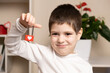 © Zarina Lukash - A 5 year old cute boy holds a lock with heart and smiles. Valentine's Day and Children, First Love, Preschoolers
