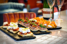 Variety Of Canapés Including Goat's Cheese Bruschetta With Champagne And Glasses At A Function/event/celebration
