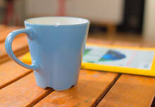 Coffee Cup On The Table With Paper