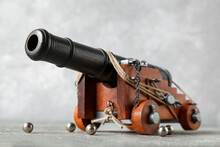 Toy Model Of Cannon On Grey Background