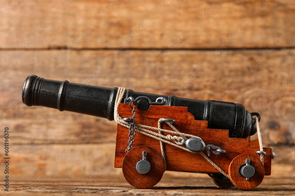 Toy model of cannon on wooden background