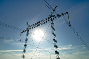 High voltage tower with electric power lines transfening electrical energy through cable wires