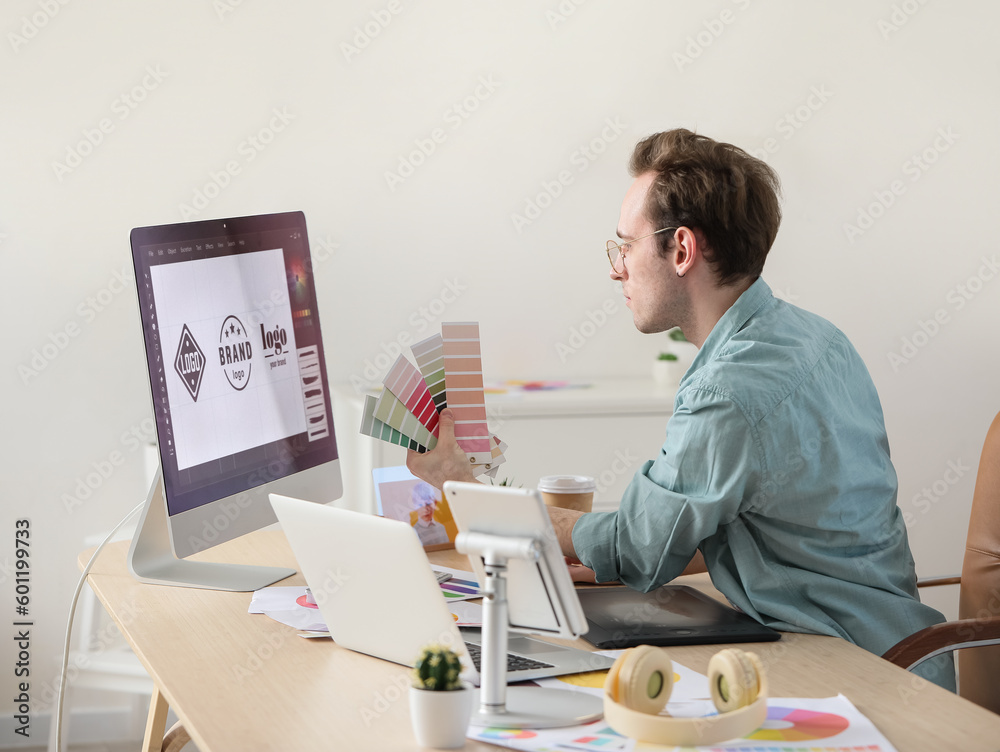 Male graphic designer developing logotype in office