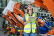 © FotoArtist - Mechanical engineers with robotic welder. Programming development technology work.. Female industrial engineer working at automated AI robotic production factory..