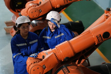 Poster - Robotics engineer working on maintenance of robotic arm in factory warehouse. Business technology.