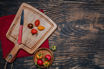 Wall Mural - cherry tomatoes and knife on cutting board