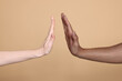 © New Africa - International relationships. People giving high five on light brown background, closeup