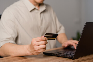 Poster - Adult man using laptop to register via credit card to shop online. Credit card secure online shopping and payment. Technology internet banking storage network concept.