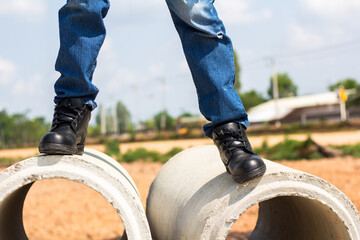 Wall Mural - Wear safety shoes to ensure safety at work. construction workers wear safety shoes. People with factory safety concept