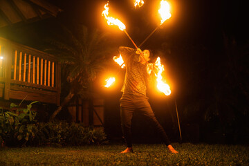 Man performs a fire dance spinning in Hawaii