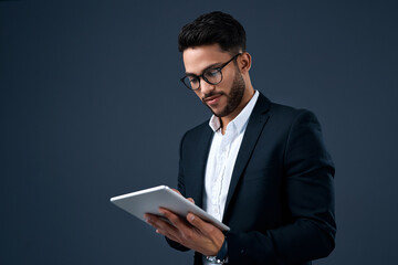 Fototapete - Technology, professional young businessman with tablet and in a studio background. Social networking or digital communication, isolated and male person with mobile device search on backdrop.