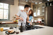 © Chanelle Malambo/peopleimages.com - Love, food and cooking with couple in kitchen and hugging for breakfast, morning and happiness. Smile, care and nutrition with man and woman eating at home for happy, health and hungry together
