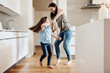 © Grady Reese/peopleimages.com - Happy, dance and a child with a mother in the kitchen, bonding and quality time together. Smile, laughing and a mom teaching her daughter with dancing, love and happiness with fun in a house