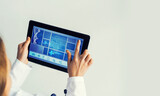 Fototapeta  - Close of female doctor hands working with tablet pc computer