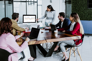 latin business partners having meeting on table with laptop and computer at office in Mexico Latin America, hispanic people working