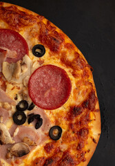 Poster - Pizza with sausage and mushrooms on a black background