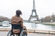 Exploring Paris as a wheelchair user. Back of disabled african american woman looking on Eiffel tower. Generative AI.