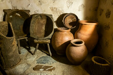 Old Clay Pots And Wooden Baskets In The Pantry Of Traditional Medieval Kitchen In An Old Monastery Or Convent