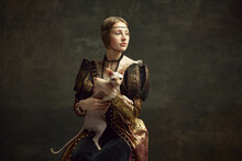 Portrait Of Beautiful Young Girl In Elegant Clothing Over Dark Vintage Background Posing With Sphynx Cat. Lady With Ermine Remake. Concept Of History, Renaissance Art Remake, Comparison Of Eras