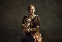 Portrait Of Pretty Young Girl In Elegant Retro Clothing Over Dark Vintage Background Posing With Sphynx Cat. Lady With Ermine Remake. Concept Of History, Renaissance Art Remake, Comparison Of Eras