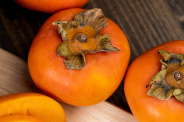 Whole ripe orange persimmon on the table