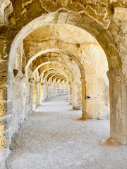 Wall Mural - A photo of the upper balcony walkway and arches in Aspendos ancient theater, emphasizing its architectural beauty and scale.