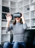 Fototapeta Sypialnia - Businesswoman with vr headset lifestyle concept, Businesswoman wearing VR headset to playing game and touching in the air for experience virtual reality while relaxation with technology after working