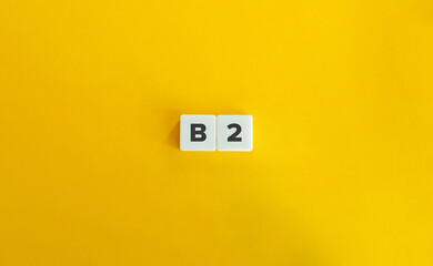 Wall Mural - b2 level of language proficiency. block letter tiles on yellow background. minimal aesthetics.
