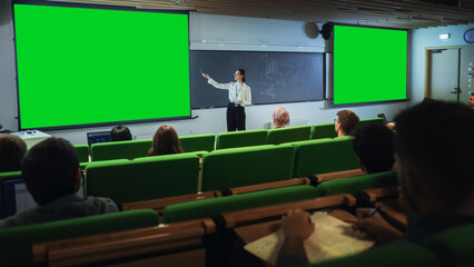 Leinwandbilder - Young Female Teacher Giving a Lecture, Showing Slides on a Green Screen Mock Up Display to a Diverse Multiethnic Group of Female and Male Students in Dark College Auditorium