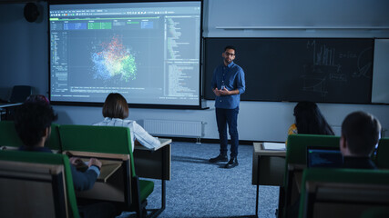 Young Male Teacher Giving a Data Science Lecture to a Diverse Multiethnic Group of Female and Male Students in a Dark College Space. Projecting Slideshow with a Neural network Model