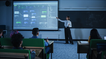 Fototapete - Young Female Teacher Giving a Data Science Lecture to Diverse Multiethnic Group of Female and Male Students in Dark College Room. Projecting Slideshow with Neural Network Model