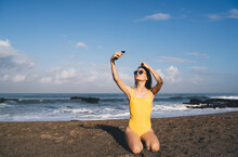 Happy Woman In Swimsuit Taking Selfie With Smartphone