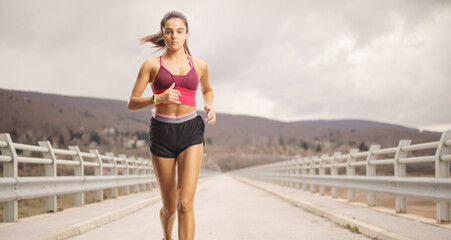 Sticker - Female athlete running at a bridge