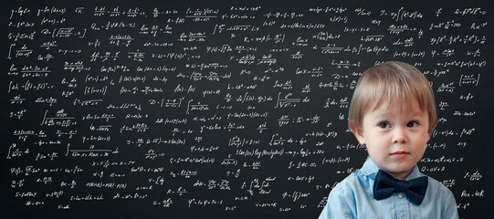 Wall Mural - portrait of a little boy with a blackboard background, mathematical formulas and difficult calculations on a school blackboard